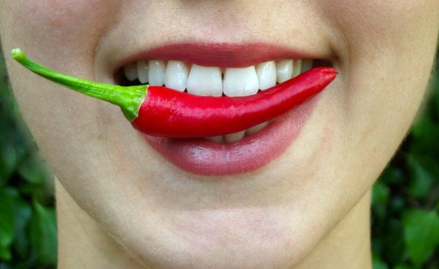Woman eating-chilli-red-pepper