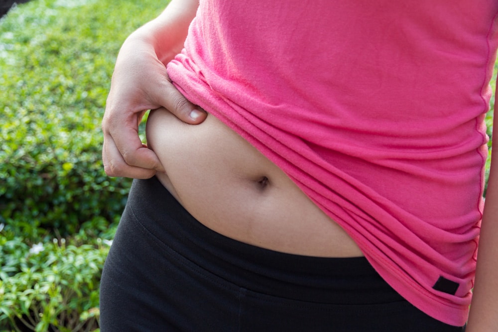 Woman planning to be pregnant considers how to lose belly fat